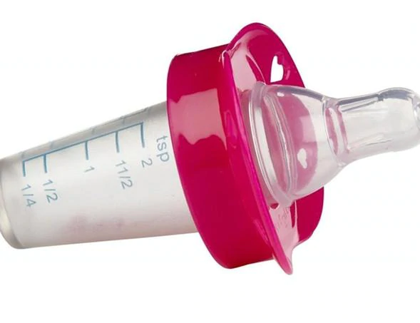 child is sick, getting medicine into their mouths with a syringe